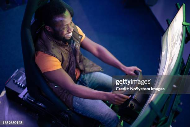 young man play car racing online video games - simulator stockfoto's en -beelden