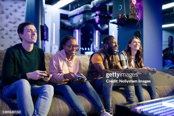 group of friends playing a multiplayer video game - massively multiplayer online game stock pictures, royalty-free photos & images