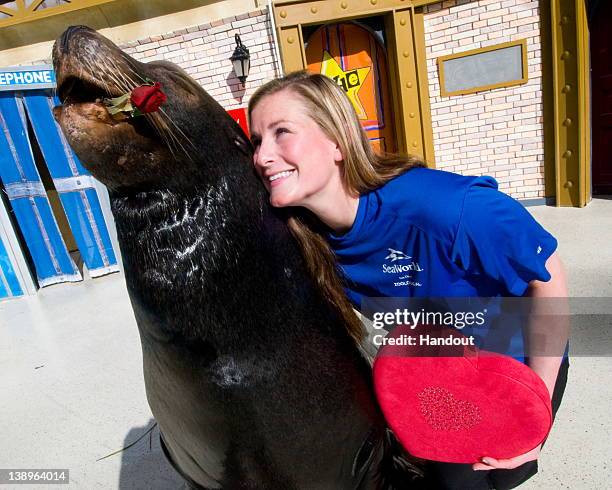 In this handout image provided by SeaWorld, SeaWorld San Diego trainer Summer Matthews celebrates Valentine's Day with Clyde, a California sea lion...