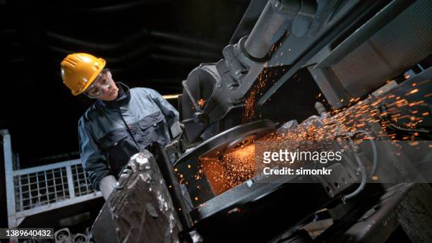 female worker grinding product - steel worker stock pictures, royalty-free photos & images