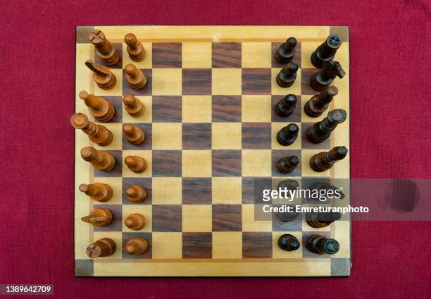 chess board on a red table cloth. - chess board stock pictures, royalty-free photos & images