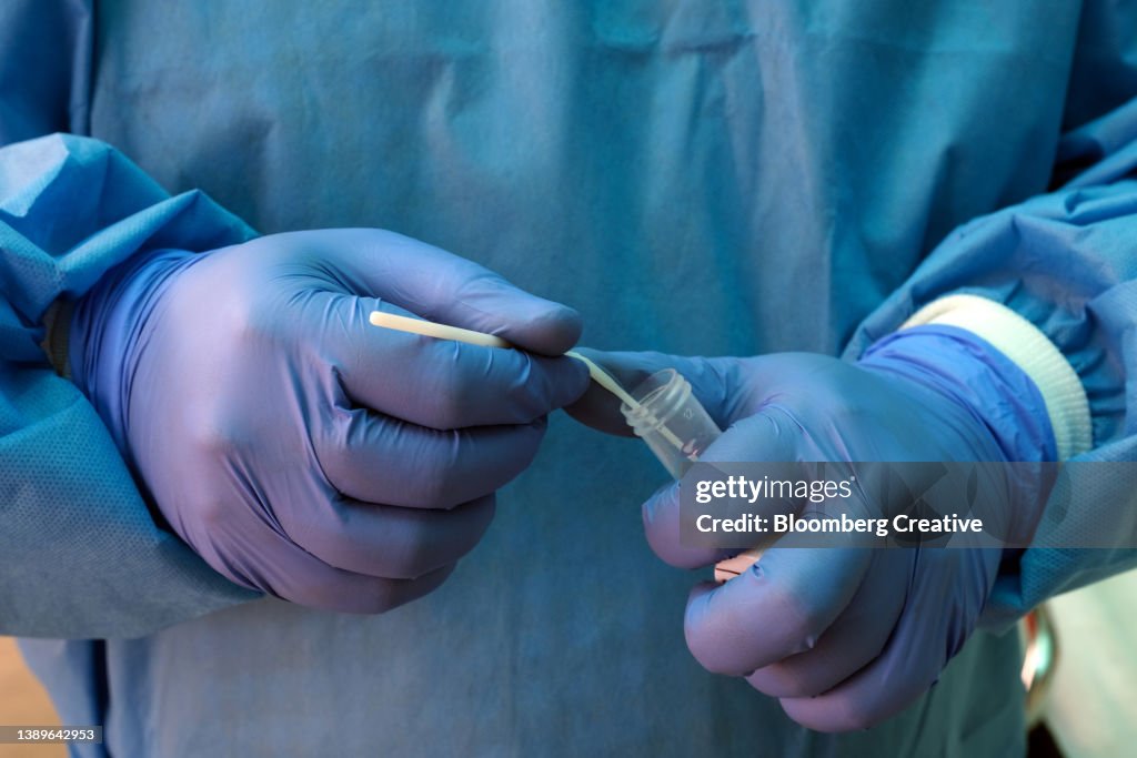 A Healthcare Worker Prepares A Covid-19 Test