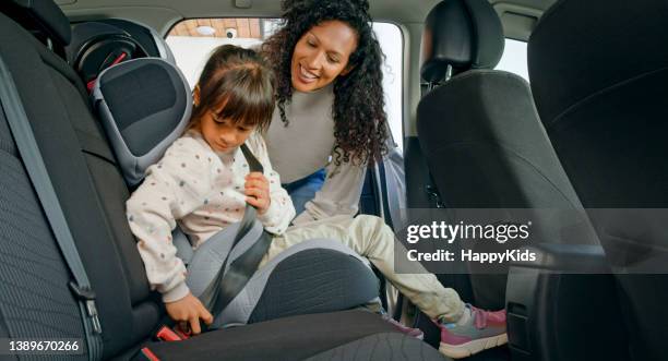 daughter fastening seat belt - seatbelt stock pictures, royalty-free photos & images