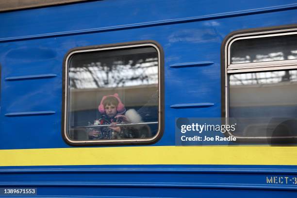 Child looks out the window of a train as it arrives at the main train station from Zaporizhzhia on April 05, 2022 in Lviv, Ukrain. More than 4...