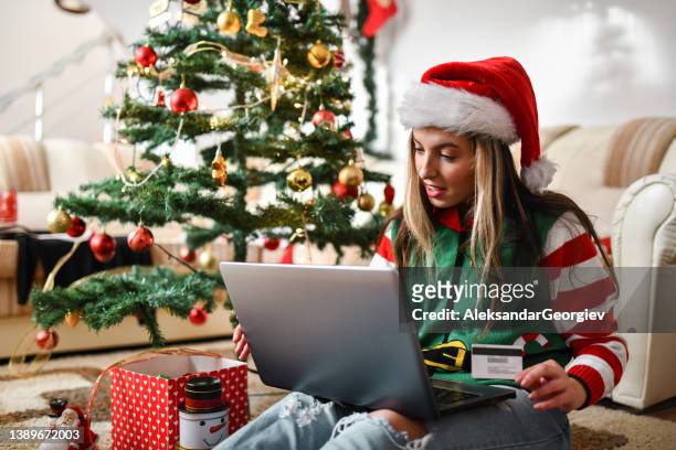 happy female looking gifts online for family - open banking stock pictures, royalty-free photos & images