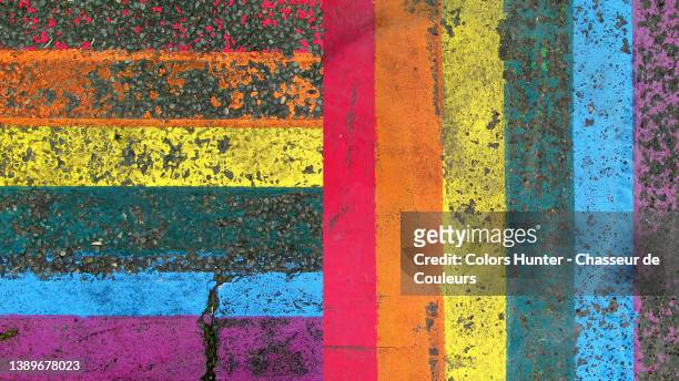 photomontage of lgbt community flag painted and patinated on asphalt in paris - pride flag stock pictures, royalty-free photos & images