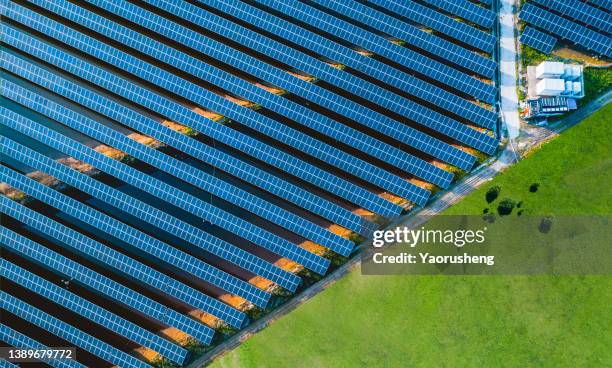 high angle view of solar panels , agricultural landscape - solar farm stock-fotos und bilder