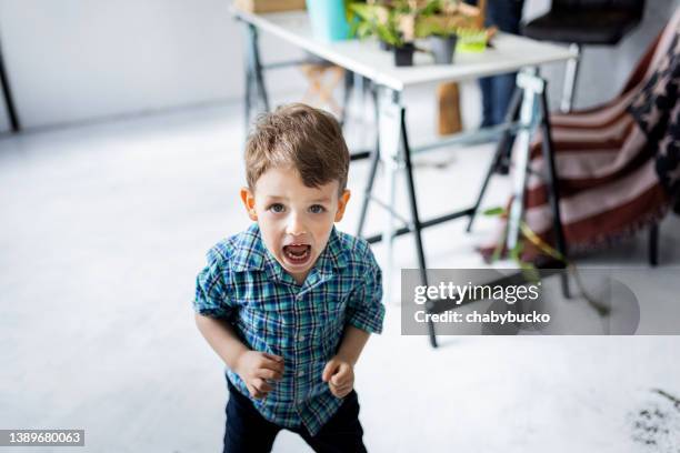 angry little boy at home looking at camera - child aggression stock pictures, royalty-free photos & images