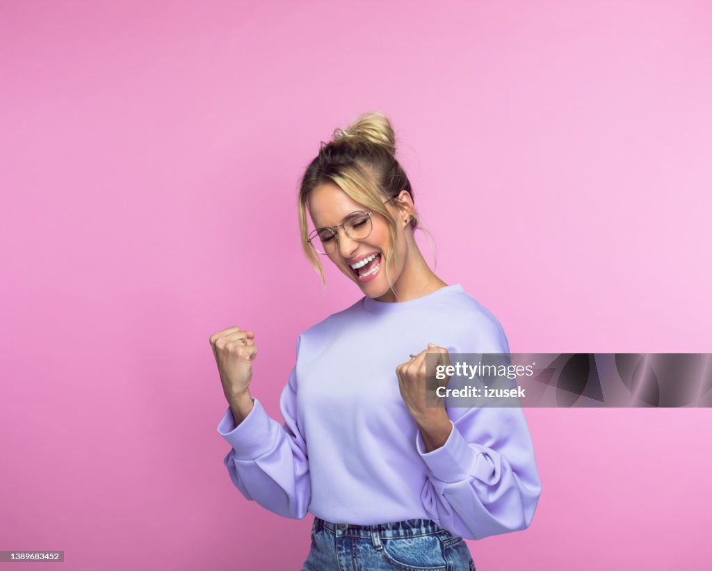 Cheerful woman with clenched fists
