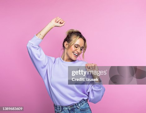 Happy woman dancing against pink background Happy woman dancing against pink background