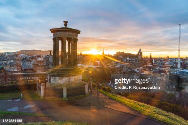 historic edinburgh taken from calton hill at dusk with lens flare edinburgh scotland united kingdom - business history stock pictures, royalty-free photos & images