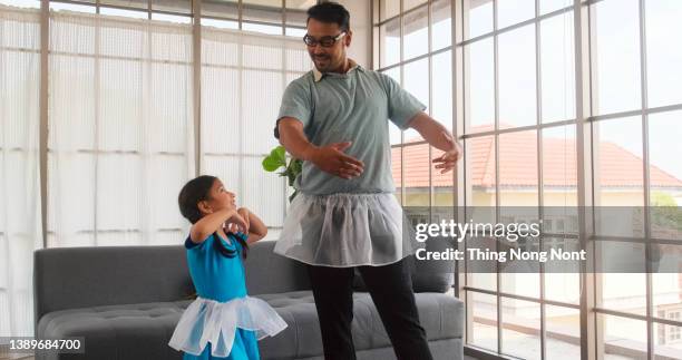 i love you, dad - handsome young man is dancing at home with his little cute girl. happy fathers day - mini dress bildbanksfoton och bilder