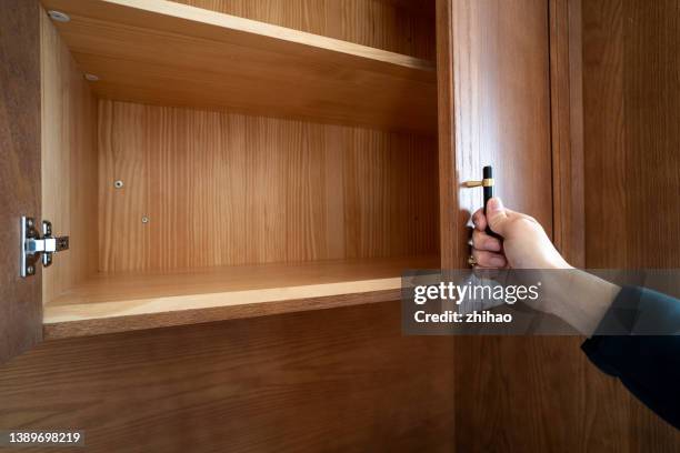 cabinet with open door - cabinet stock pictures, royalty-free photos & images