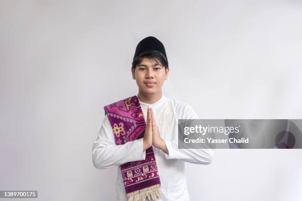 studio shot of muslim teen boy - ramadan greeting stock pictures, royalty-free photos & images