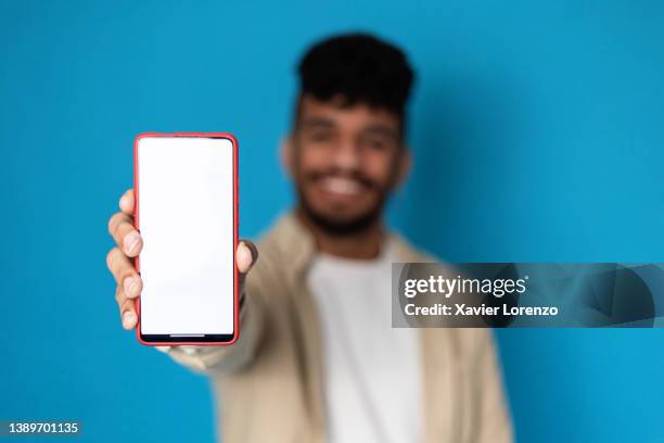 man showing smartphone with blank white screen. - man holding his hand out foto e immagini stock