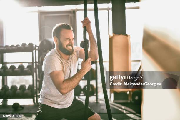 rope training for male athlete in gym - perfect stock pictures, royalty-free photos & images