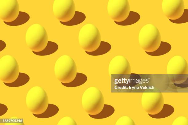 white easter egg pattern in yellow color. easter minimal concept. - hard boiled eggs stock-fotos und bilder