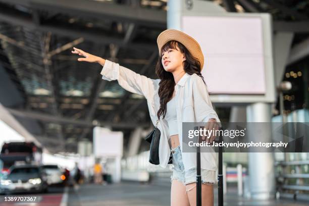 tourist is waiting a taxi in front of airport in thailand. - gesturing stock pictures, royalty-free photos & images