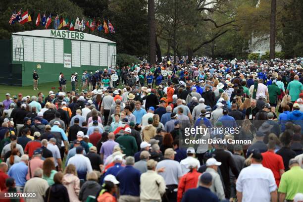 Patrons exit the course as play is suspended due to inclement weather during a practice round prior to the Masters at Augusta National Golf Club on...