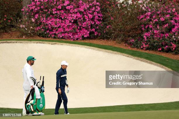 Jordan Spieth of the United States talks with his caddie Michael Greller on the 13th hole during a practice round prior to the Masters at Augusta...