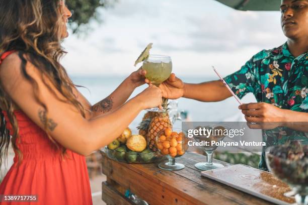 woman having a drink at the bar - caipirinha stock pictures, royalty-free photos & images