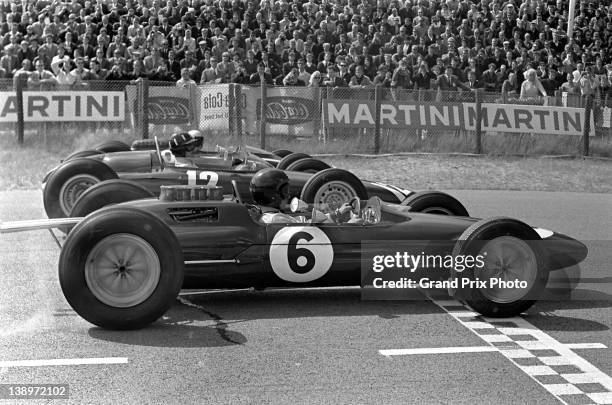 Jim Clark of Great Britain driving the Team Lotus Lotus 25 Climax V8 alongside Graham Hill in the Owen Racing Organisation BRM P57 BRM V8 and Bruce...