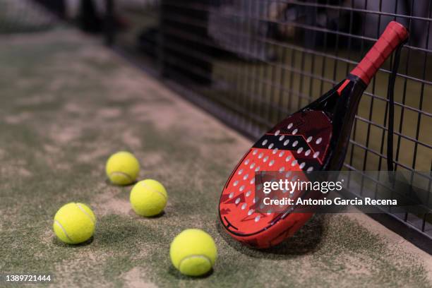 paddle tennis racket and balls in fence - paddle tennis stock pictures, royalty-free photos & images