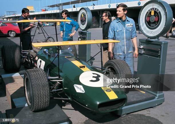 Ron Dennis oversees the scrutineering and weighing of the double high winged Brabham Racing Organisation Brabham BT26 Repco V8 of Jack Brabham during...