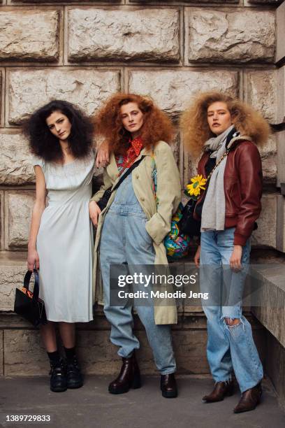 Models Effie Steinberg, Mariam de Vinzelle and Clementine Balcaen pose with big hair by Gary Gill after the Hermes show at Caserne Gendarmerie...