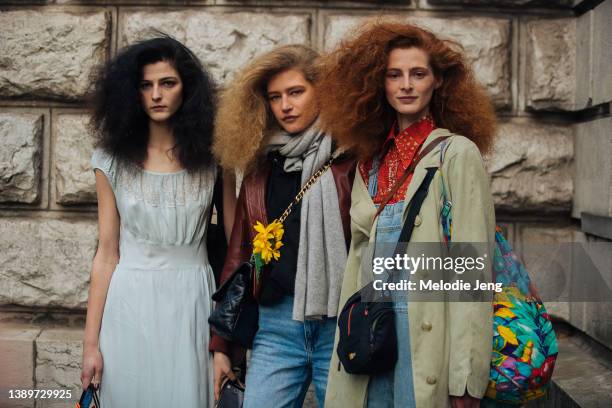 Models Effie Steinberg, Mariam de Vinzelle and Clementine Balcaen pose with big hair by Gary Gill after the Hermes show at Caserne Gendarmerie...