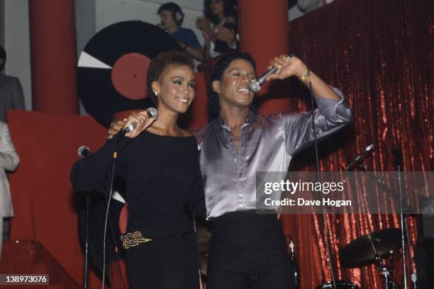 American singer Whitney Houston performs with Jermaine Jackson at The Limelight in New York City, 1st July 1984.