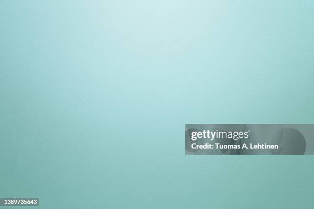 light turquoise textured paper background with light effect. copy space. - turquoise stockfoto's en -beelden