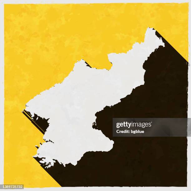 stockillustraties, clipart, cartoons en iconen met north korea map with long shadow on textured yellow background - north korea