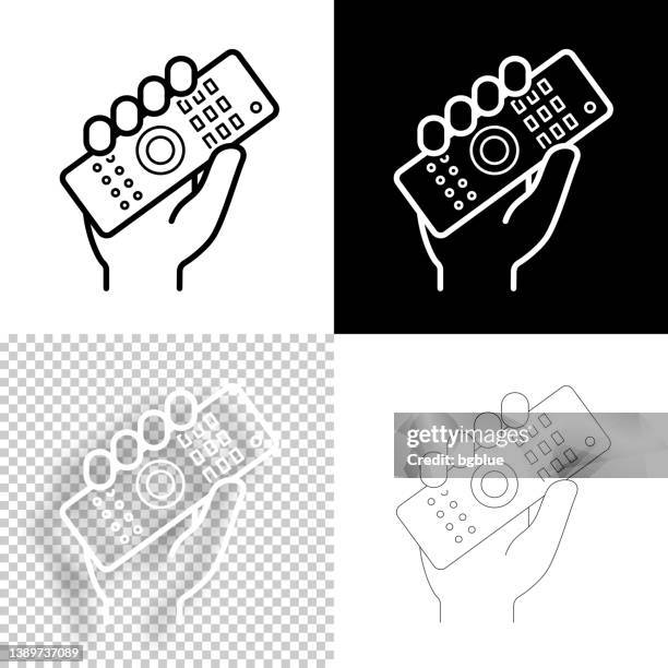 hand holding up remote control. icon for design. blank, white and black backgrounds - line icon - remote controlled 幅插畫檔、美工圖案、卡通及圖標