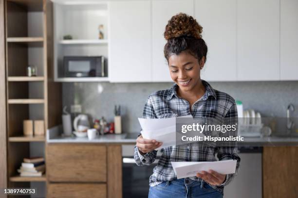 mujer feliz en casa comprobando su correo - letterbox fotografías e imágenes de stock