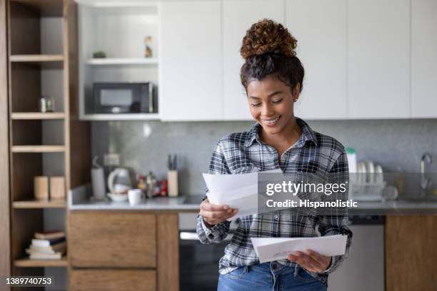 happy woman at home checking her mail - mail 個照片及圖片檔