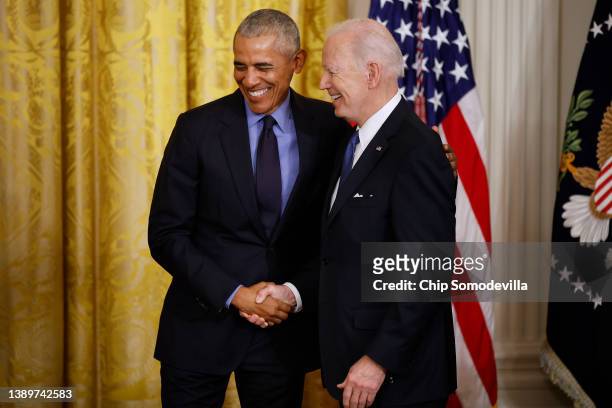 Former President Barack Obama and U.S. President Joe Biden shake hands during an event to mark the 2010 passage of the Affordable Care Act in the...