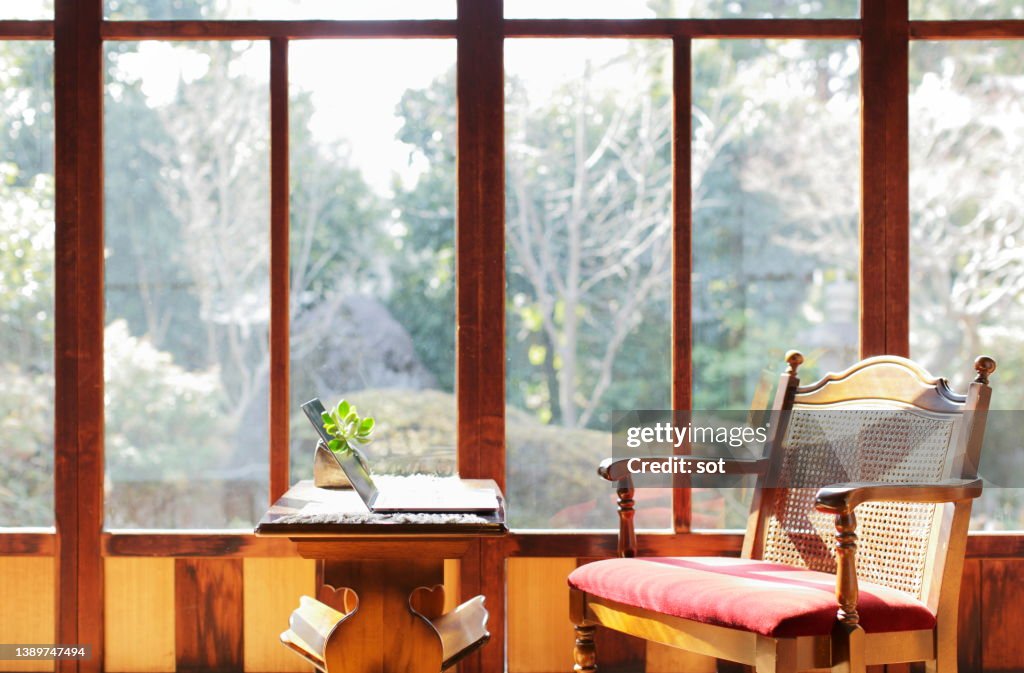 Laptop on coffee table in japanese style room facing the garden