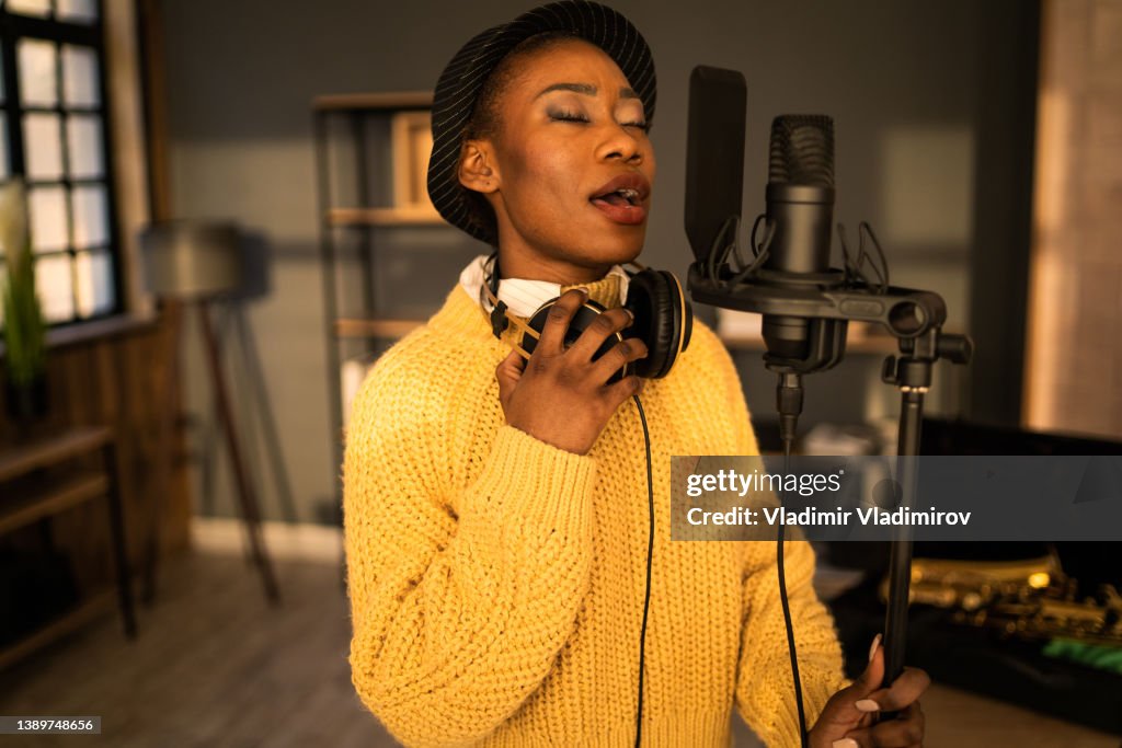 Beautiful vocalist rehearsing in a studio