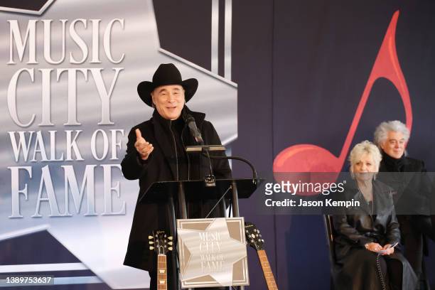 Clint Black speaks onstage as fellow inductee, Connie Smith and Marty Stuart look on at the 2022 Music City Walk f Fame Induction Ceremony at Music...