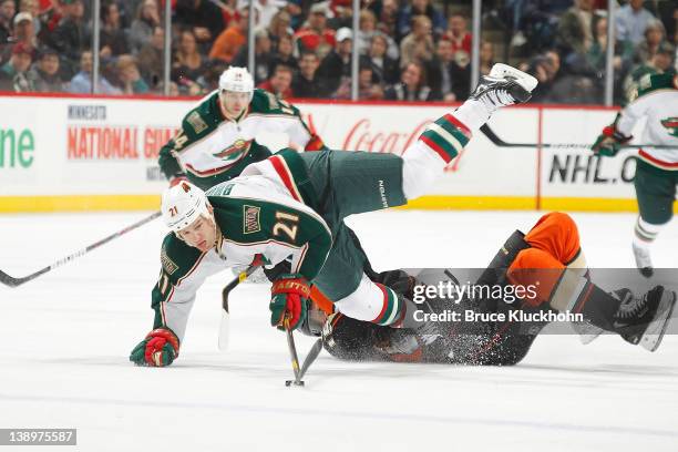 Kyle Brodziak of the Minnesota Wild and Ryan Getzlaf of the Anaheim Ducks collide during the game at the Xcel Energy Center on February 14, 2012 in...