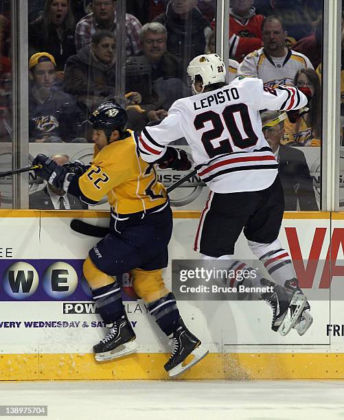 Sami Lepisto of the Chicago Blackhawks hits Jordin Tootoo of the Nashville Predators into the boards during the second period at the Bridgestone...