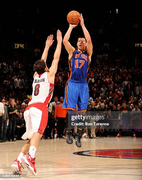 Jeremy Lin of the New York Knicks takes the game winning three pointer against Jose Calderon of the Toronto Raptors on February 14, 2012 at the Air...