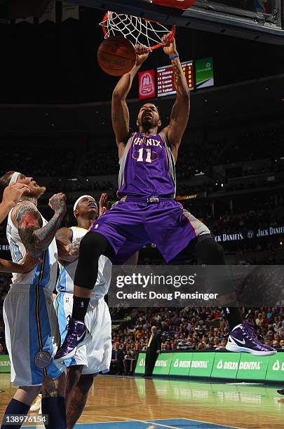 Markieff Morris of the Phoenix Suns dunks the ball against Chris Andersen and Al Harrington of the Denver Nuggets at the Pepsi Center on February 14,...