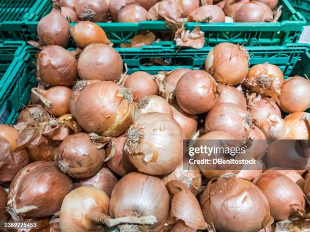 piles of onions stacked in boxes in a supermarket. concept of vegetables, ripe onions, sale, purchase, nutrition and healthy food. - onion stock pictures, royalty-free photos & images