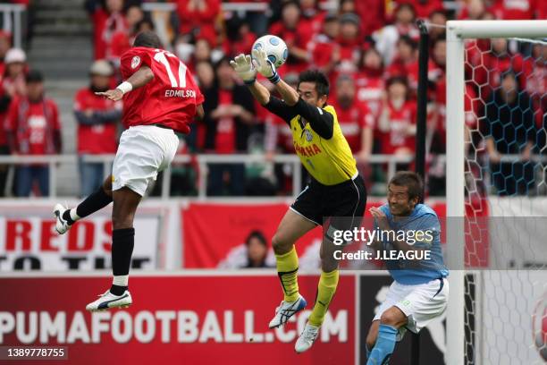 Edmilson of Urawa Red Diamonds beats Yoshikatsu Kawaguchi of Jubilo Iwata to score his side's first goal during the J.League J1 match between Jubilo...