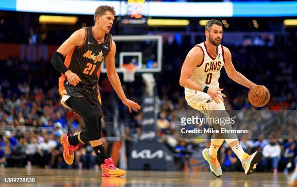 Kevin Love of the Cleveland Cavaliers drives on Moritz Wagner of the Orlando Magic during a game at Amway Center on April 05, 2022 in Orlando,...