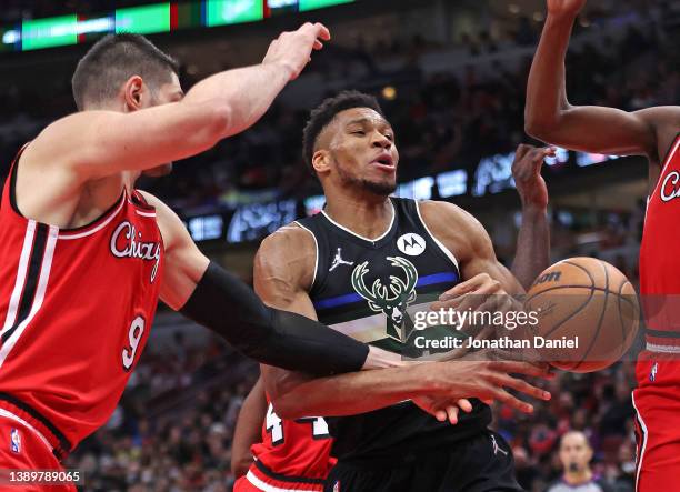 Giannis Antetokounmpo of the Milwaukee Bucks looses control of the ball after being fouled by Nikola Vucevic of the Chicago Bulls at the United...