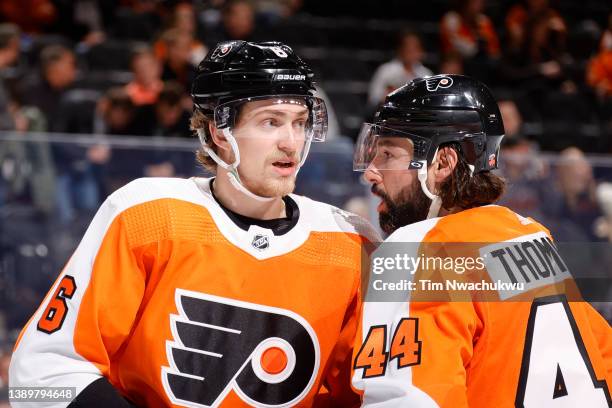 Travis Sanheim and Nate Thompson of the Philadelphia Flyers speak during the third period against the Columbus Blue Jackets at Wells Fargo Center on...