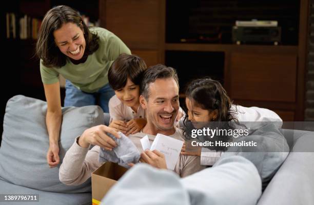 happy father opening his gift for father's day with his family - open day 8 stock pictures, royalty-free photos & images